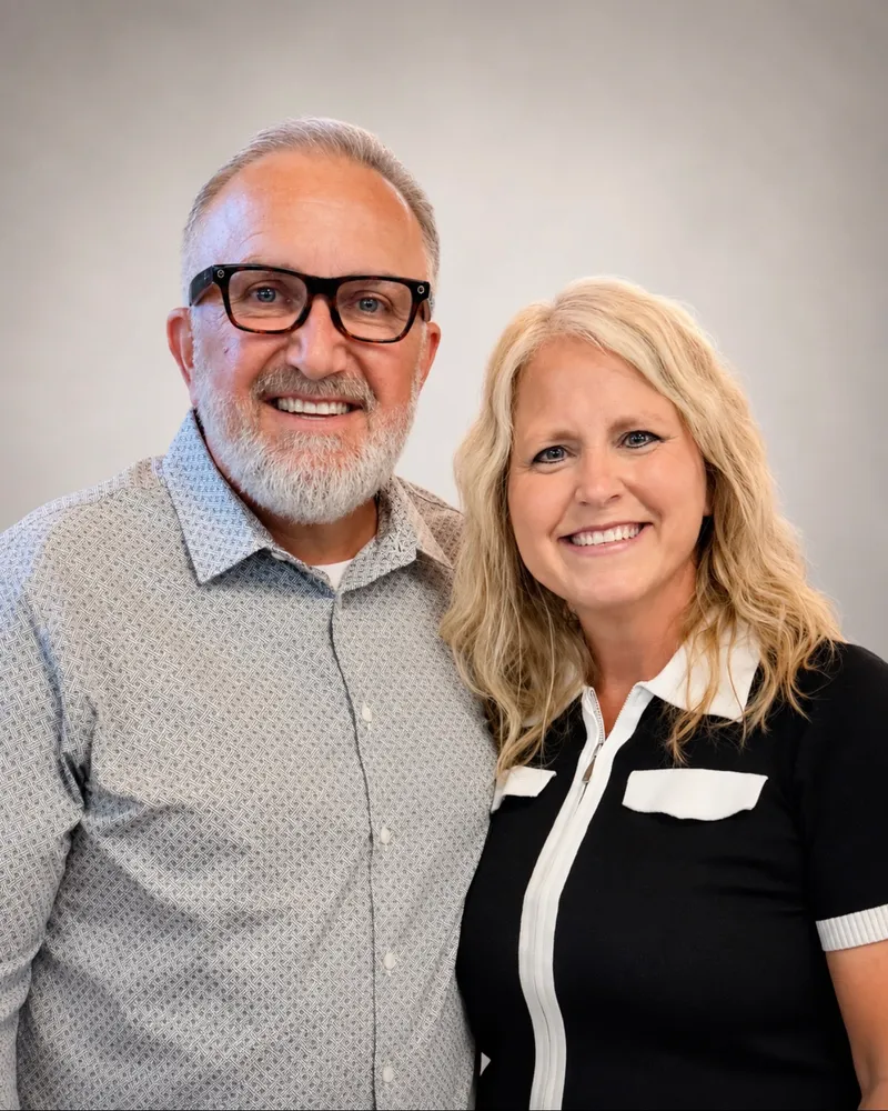 Pastors James and Cathie Hightshoe smiling together, a studio portrait